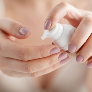 woman applying moisturizer