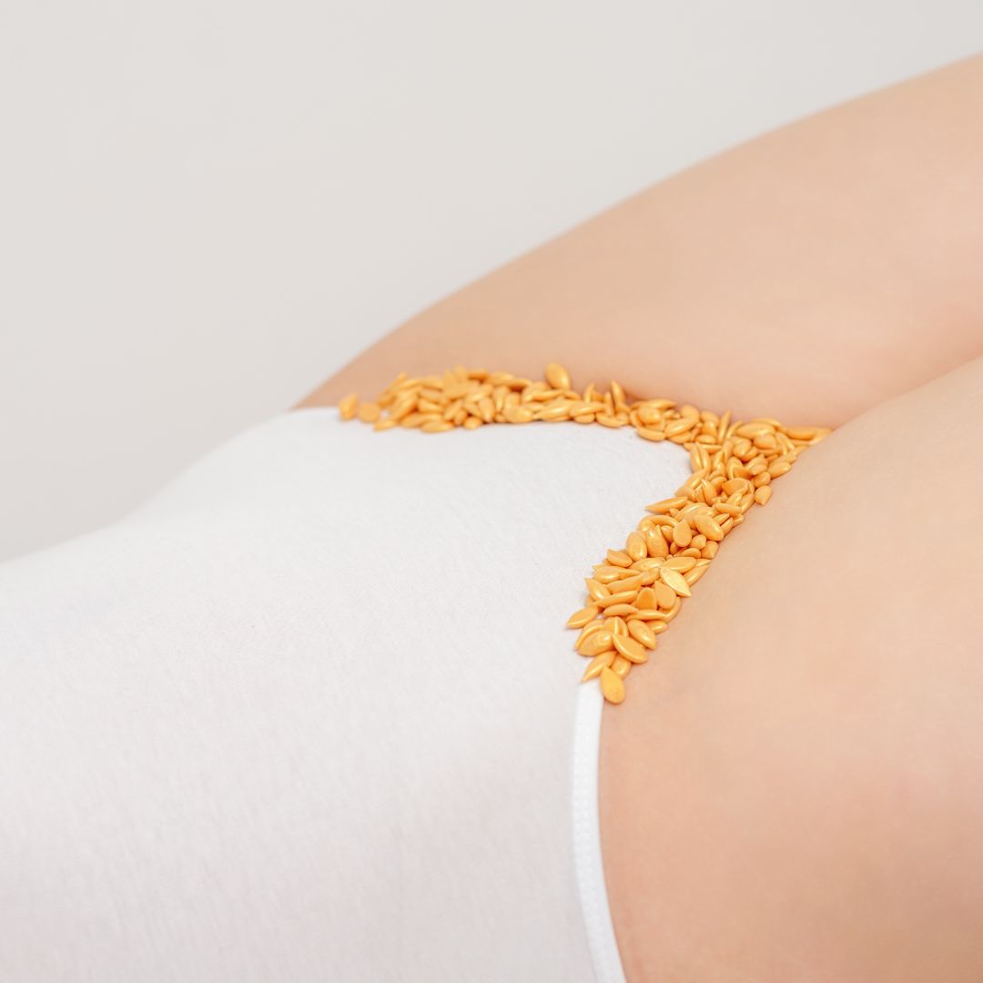Woman with unmelted wax lining her bikini area.